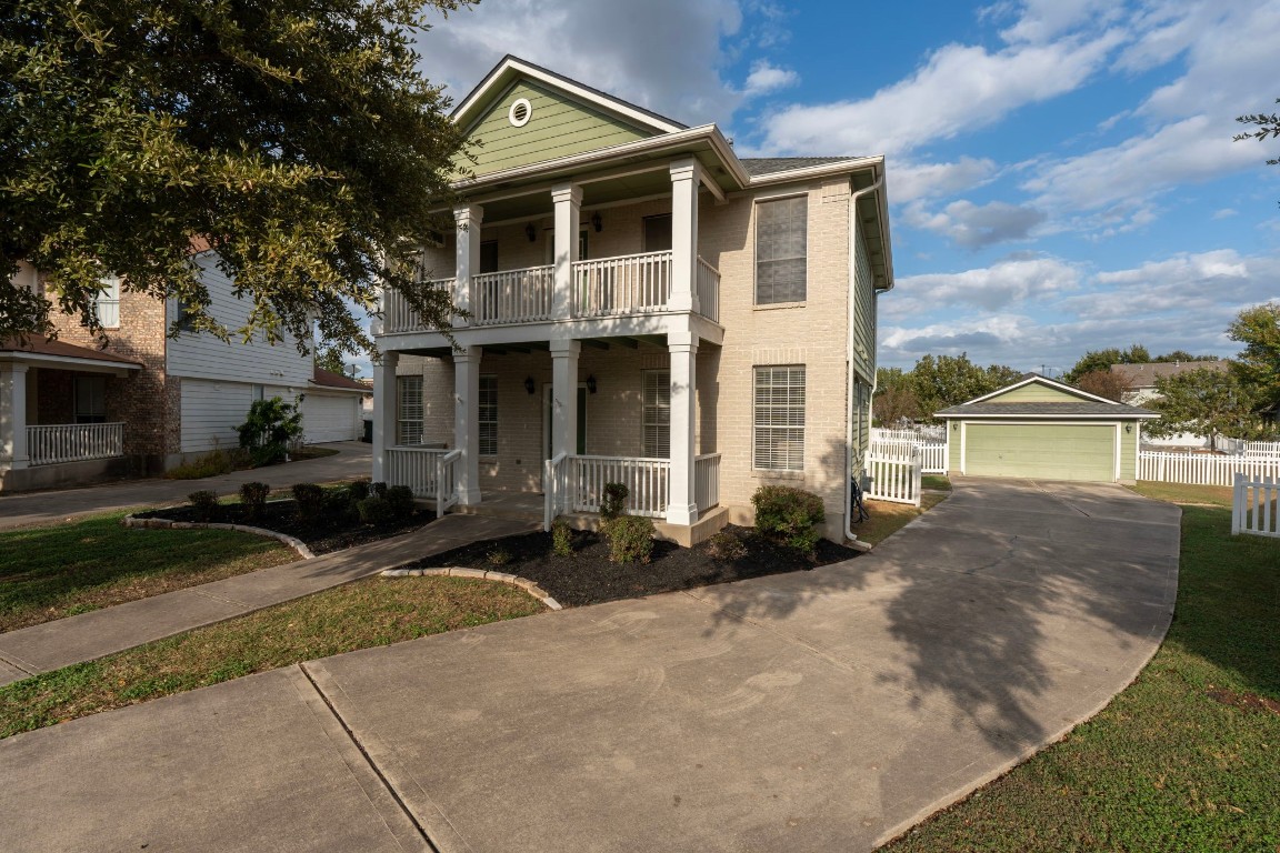 a front view of a house with garden and patio