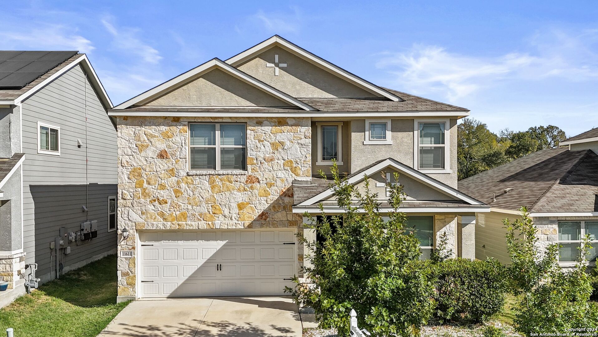 a front view of a house with a yard and garage