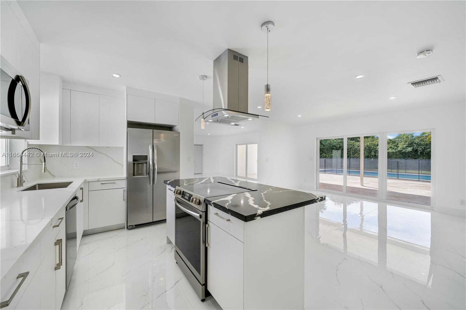 a kitchen that has a sink and a stove top oven