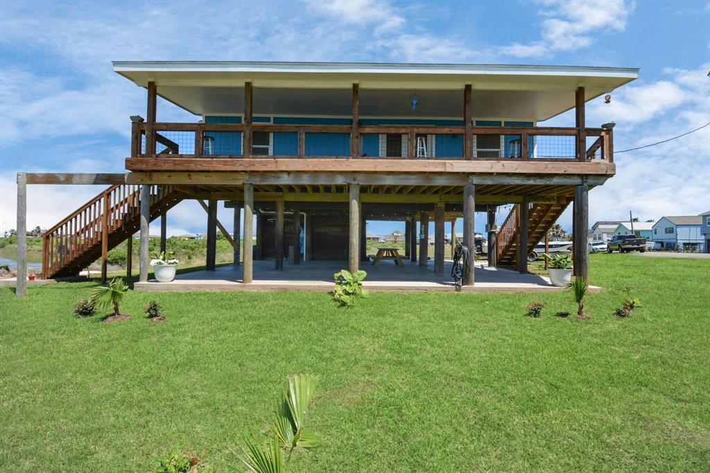 a view of a house with backyard porch and sitting area