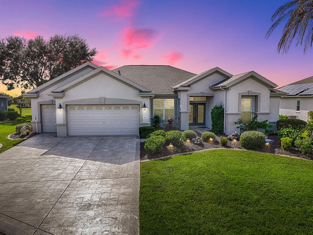 a front view of a house with a yard and garage