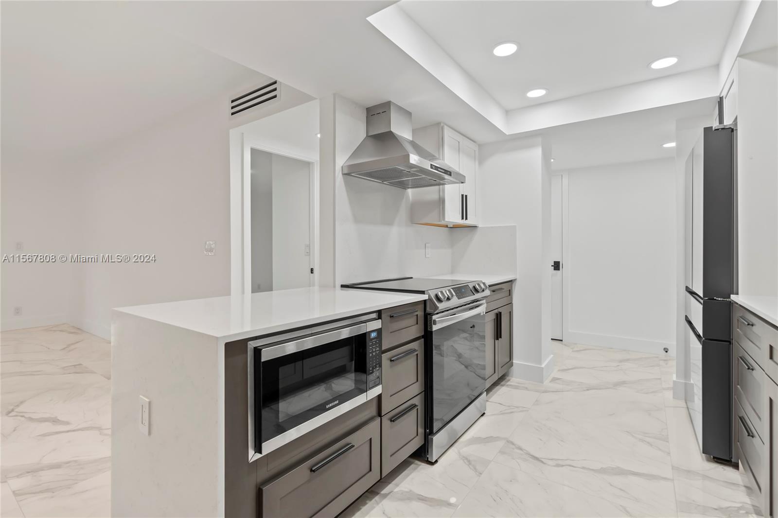 a kitchen with stainless steel appliances a stove and a refrigerator