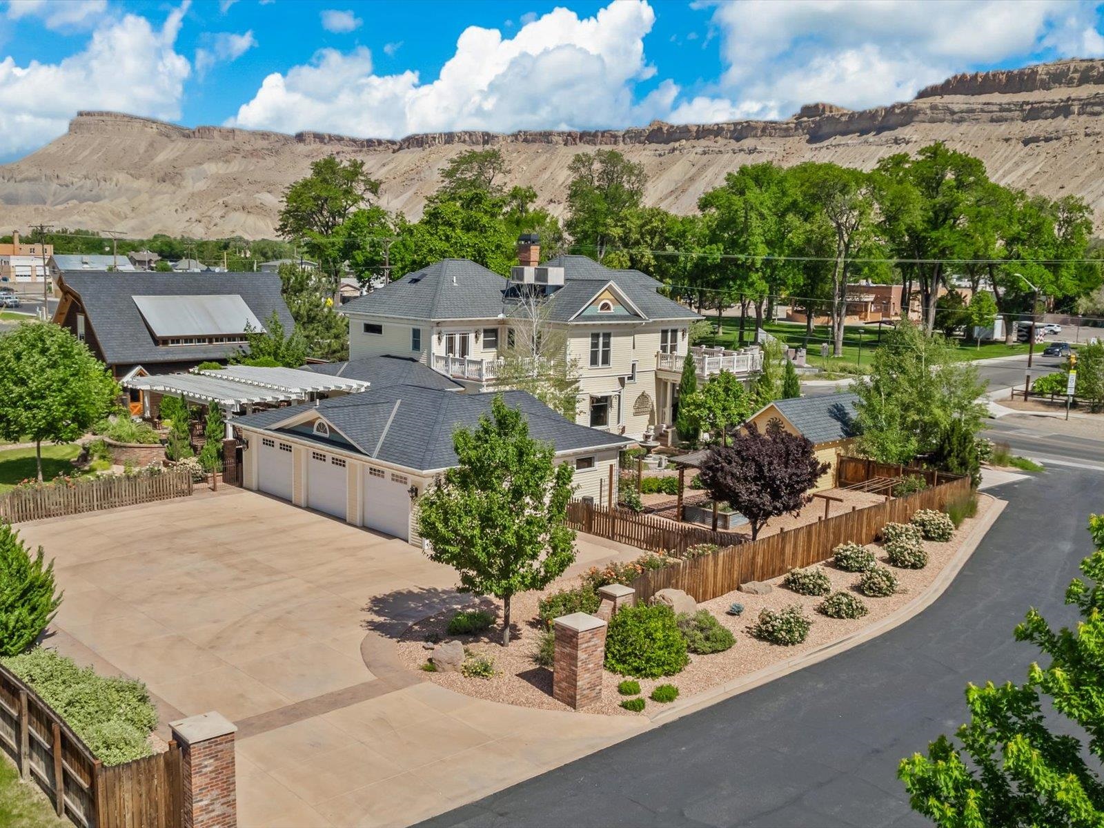 an aerial view of a house with a garden and lake view