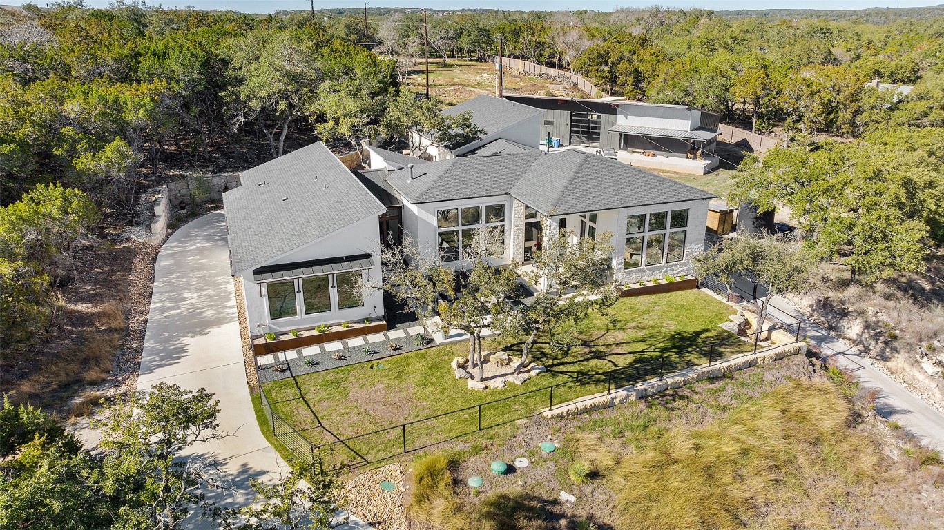 an aerial view of a house with a yard