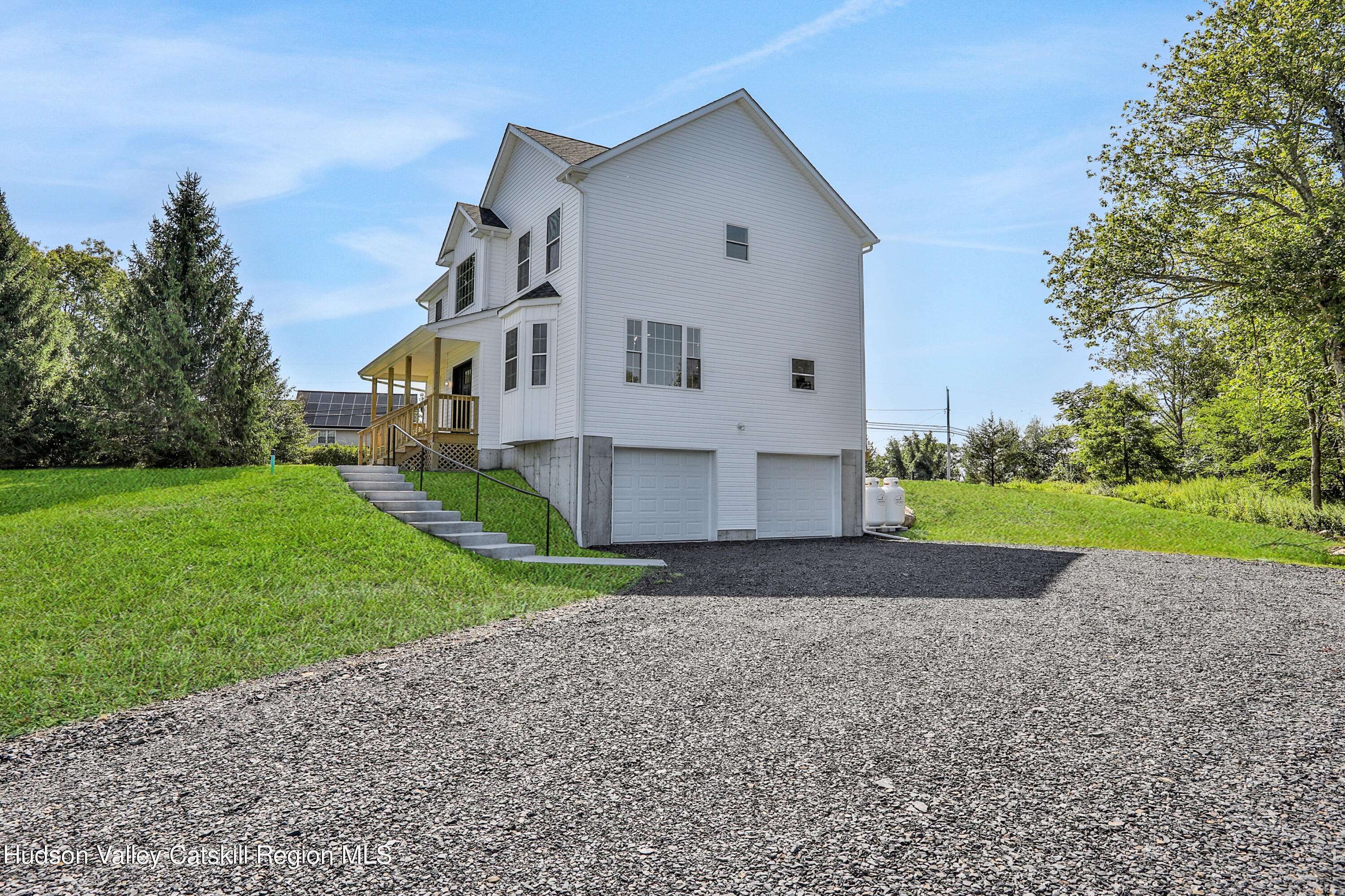 a front view of house with yard and green space