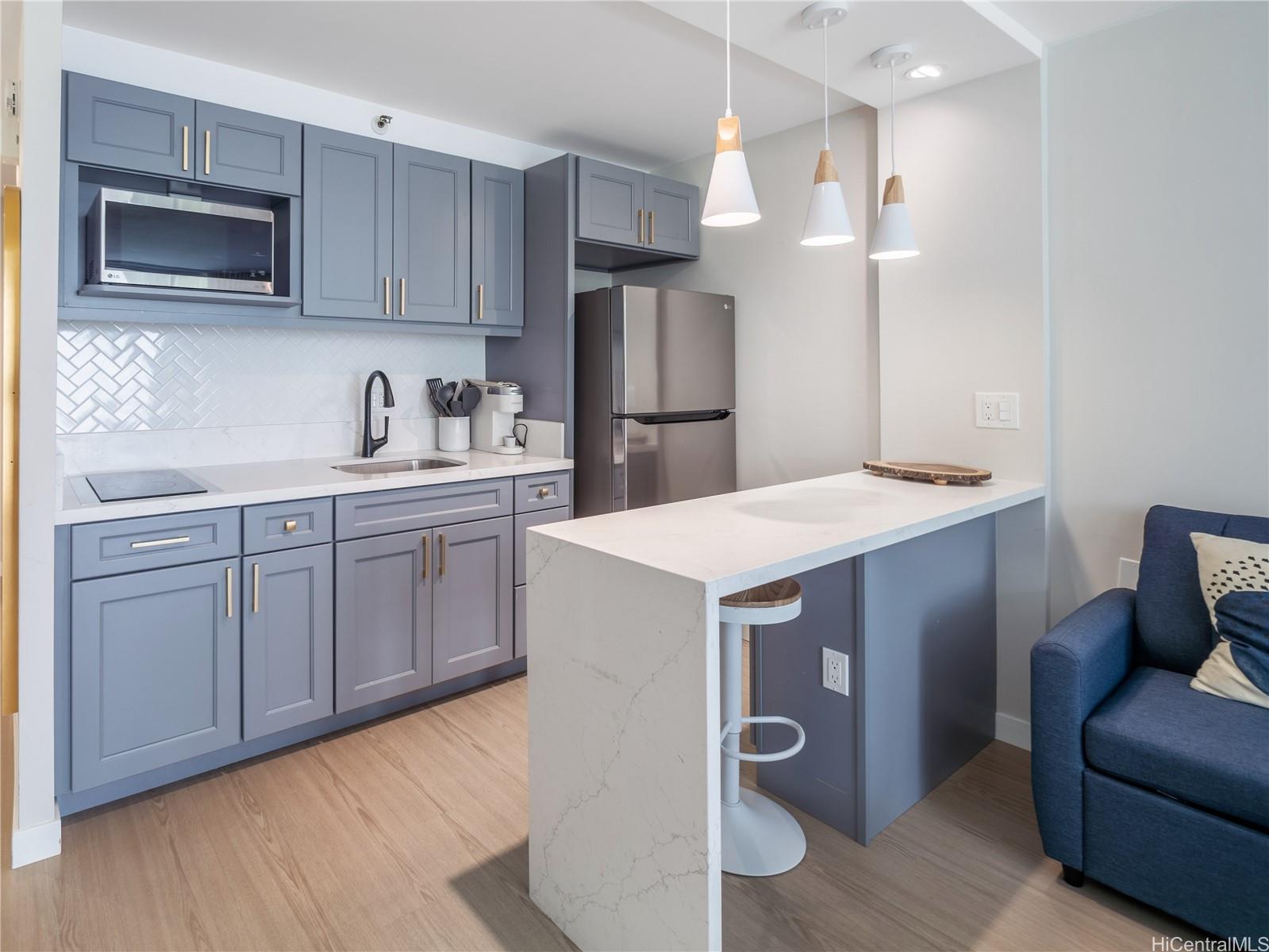 a kitchen with a sink a microwave and refrigerator