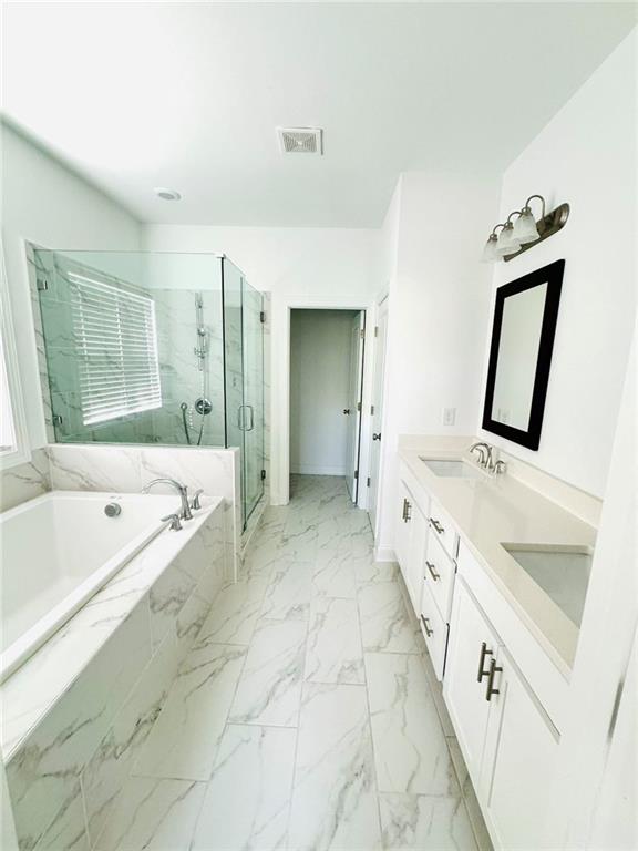 a large white tub sitting in a bathroom