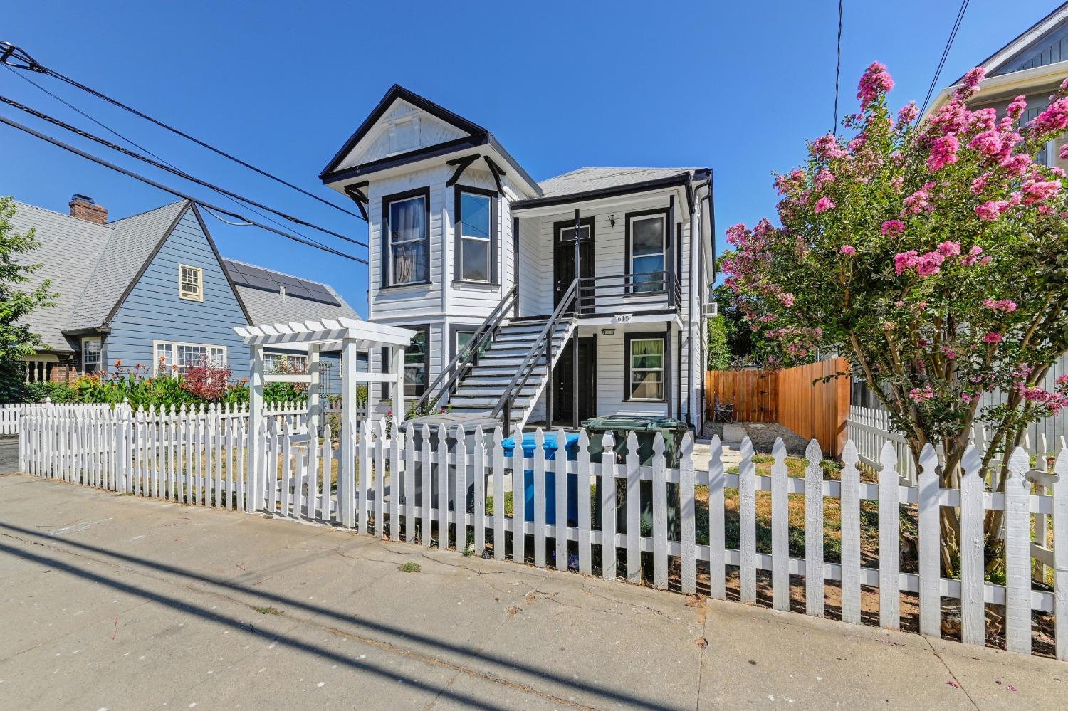 a view of a house with wooden fence