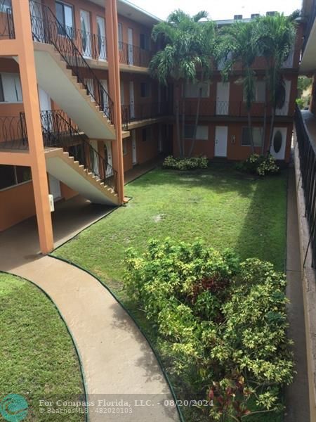 a view of a backyard with large trees