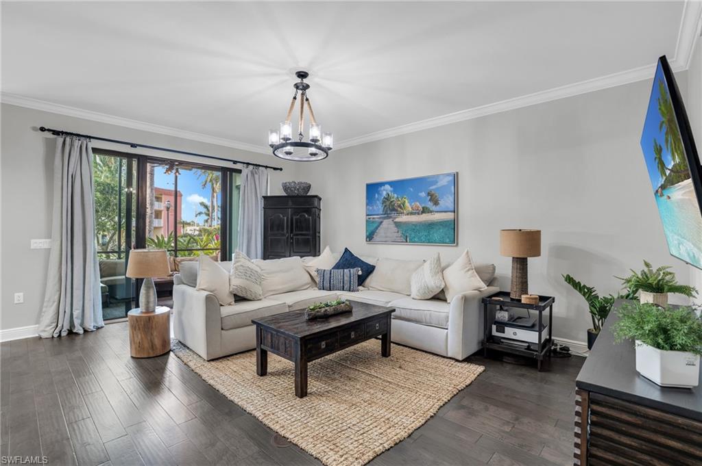 a living room with furniture and a chandelier