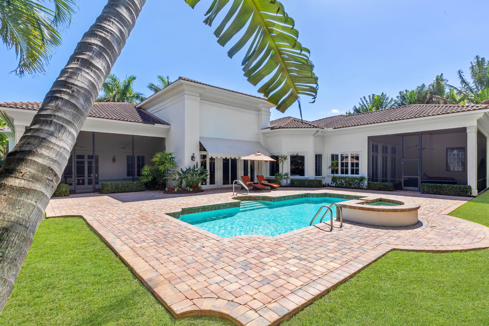 a view of a house with swimming pool and sitting area