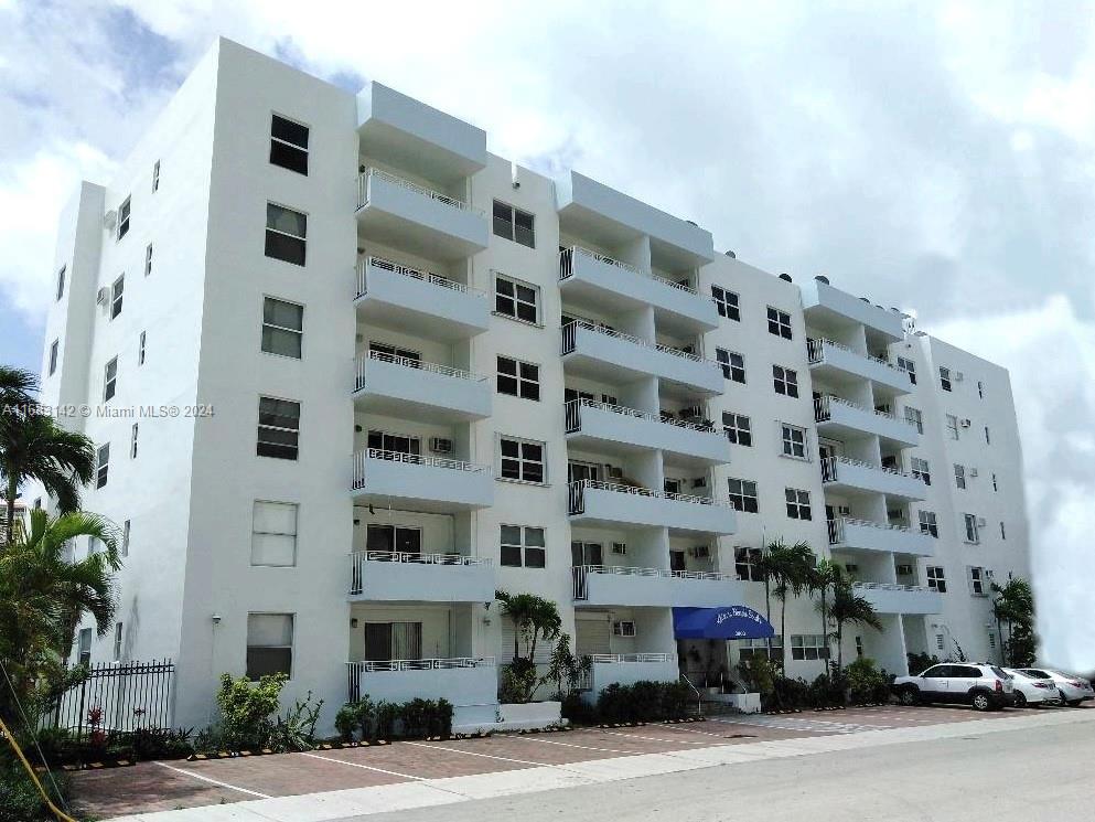 a front view of multi story residential apartment building with yard