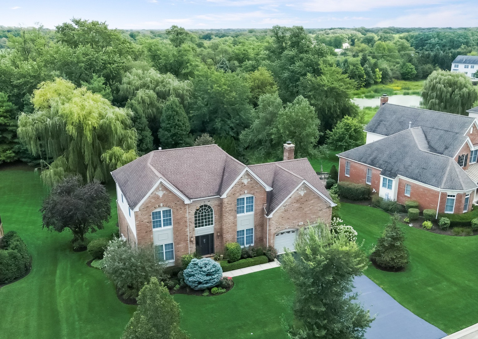 an aerial view of a house with a big yard