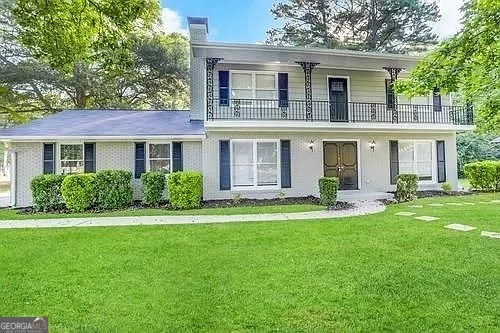 a front view of a house with a yard and porch