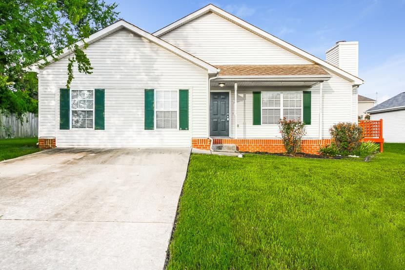 a front view of a house with a yard and porch