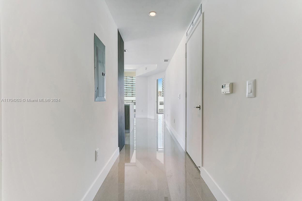 a view of a hallway with a white walls