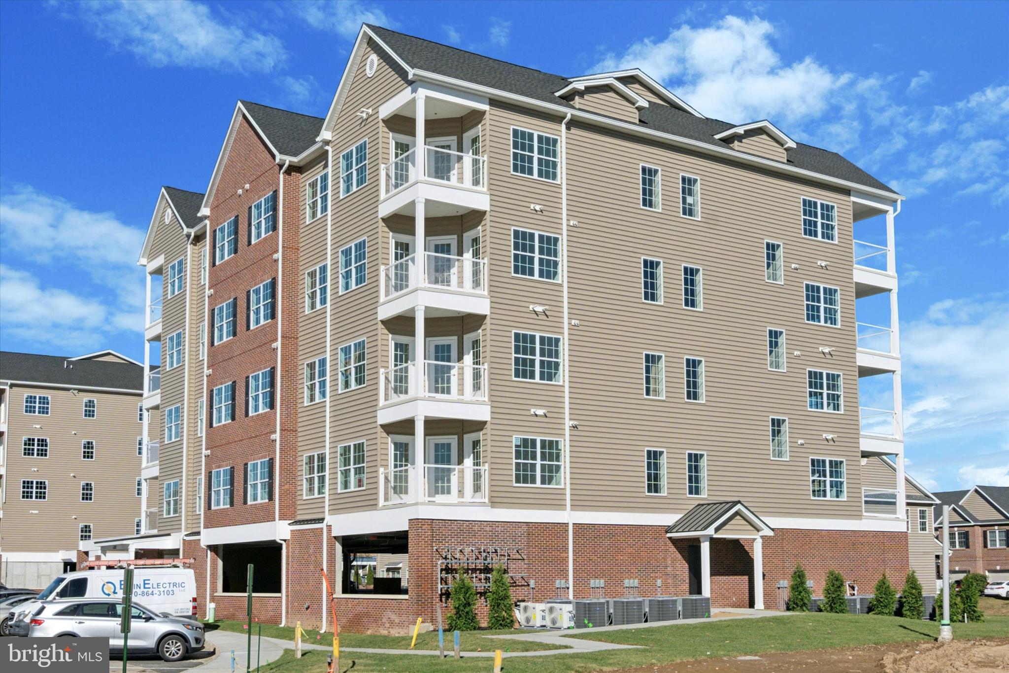 a front view of a residential apartment building with a yard