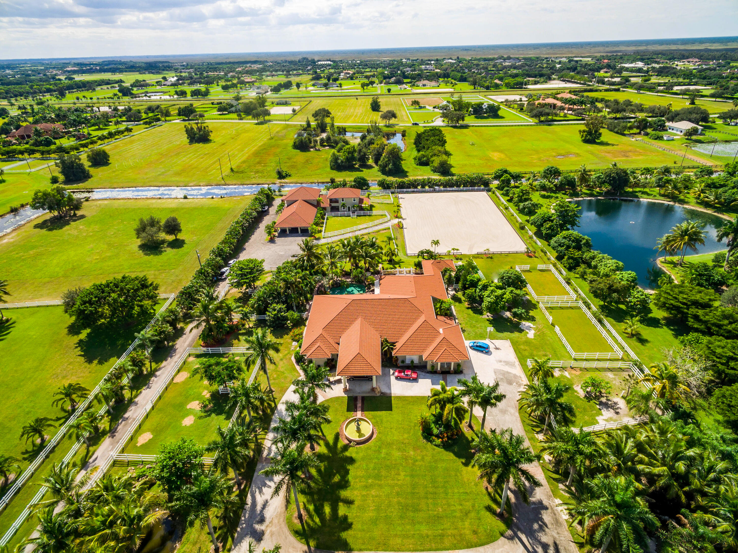 an aerial view of residential houses with outdoor space and swimming pool