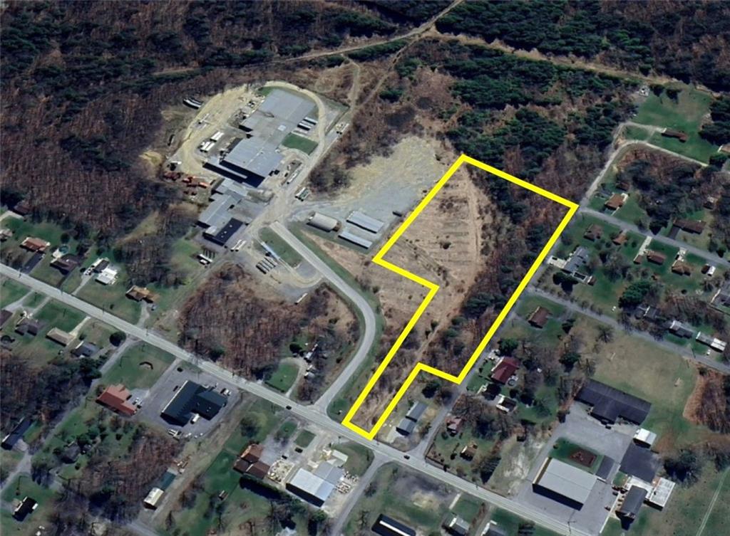 an aerial view of a house a yard and outdoor seating