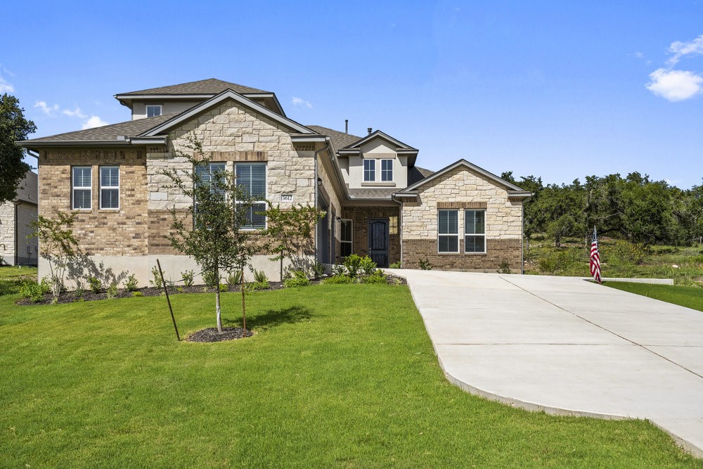 a front view of a house with a yard