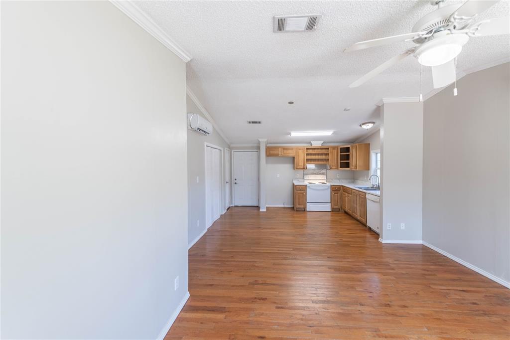 a view of kitchen and hall with wooden floor