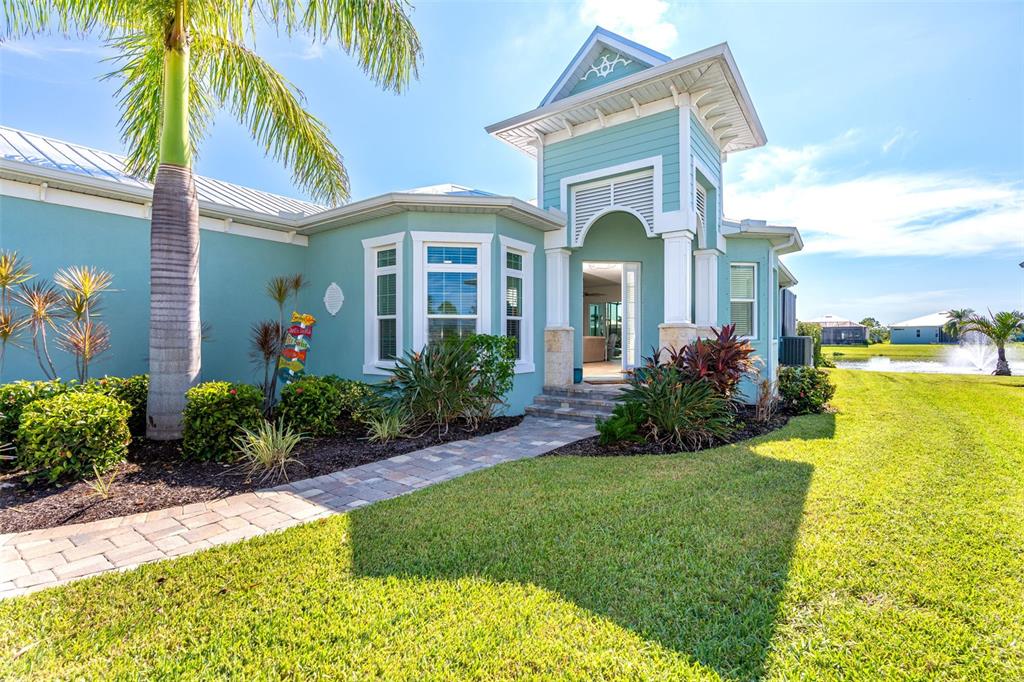 a front view of a house with a garden