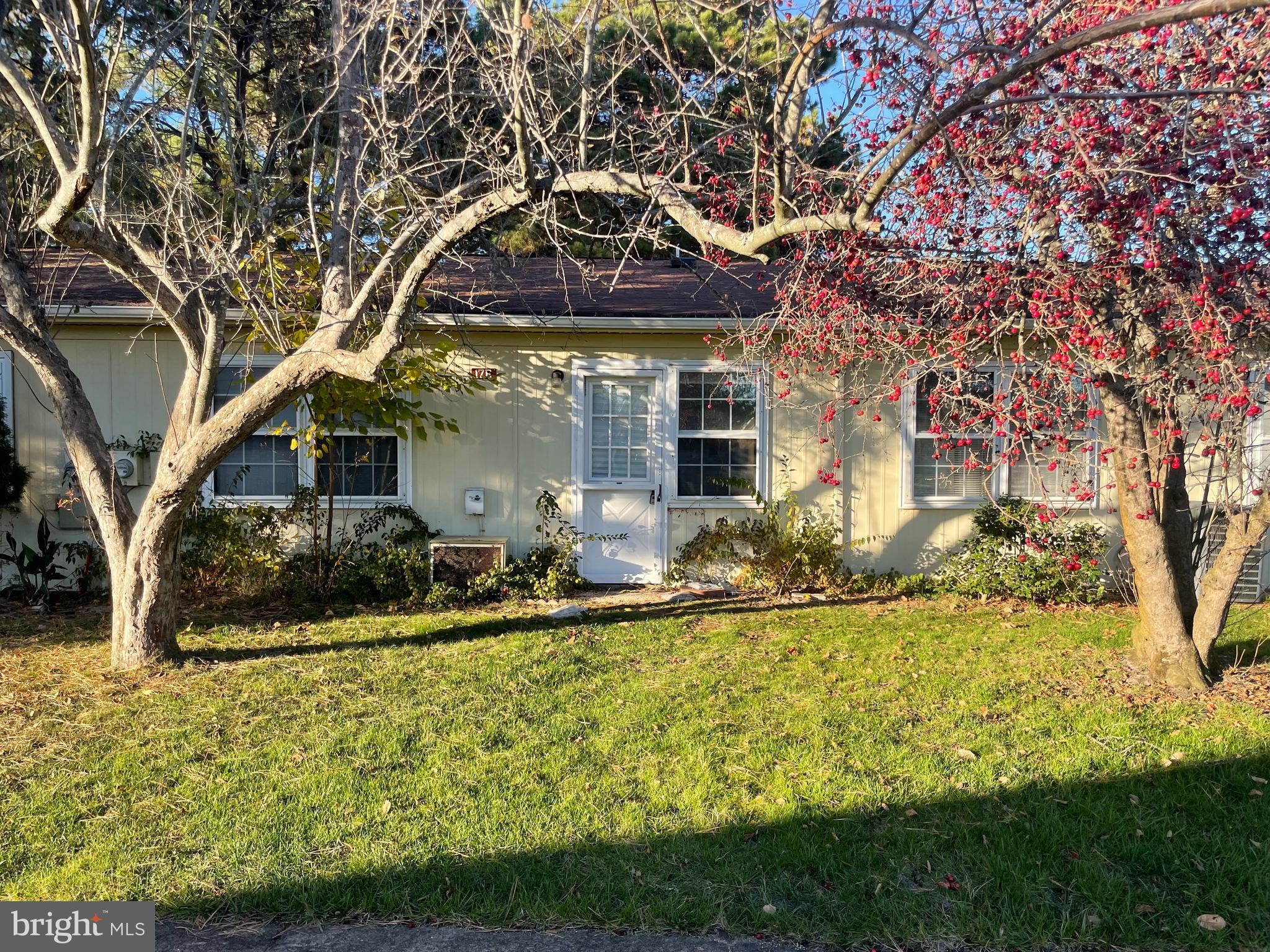 a front view of a house with swimming pool and porch with furniture