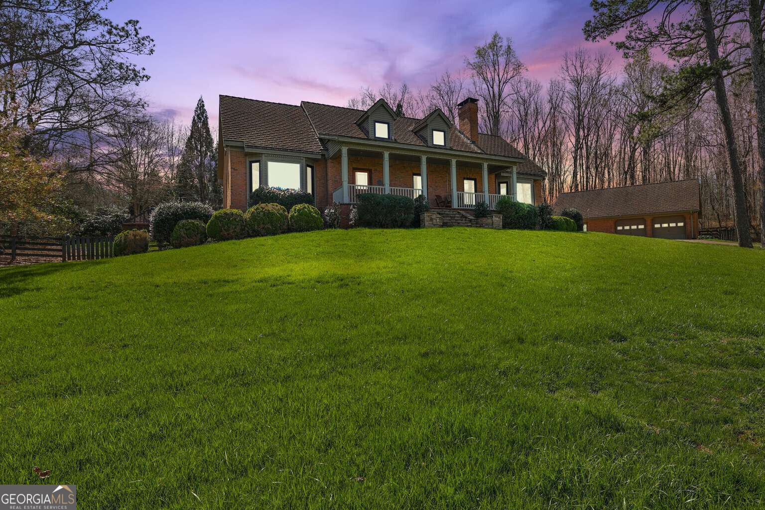 a front view of a house with a garden