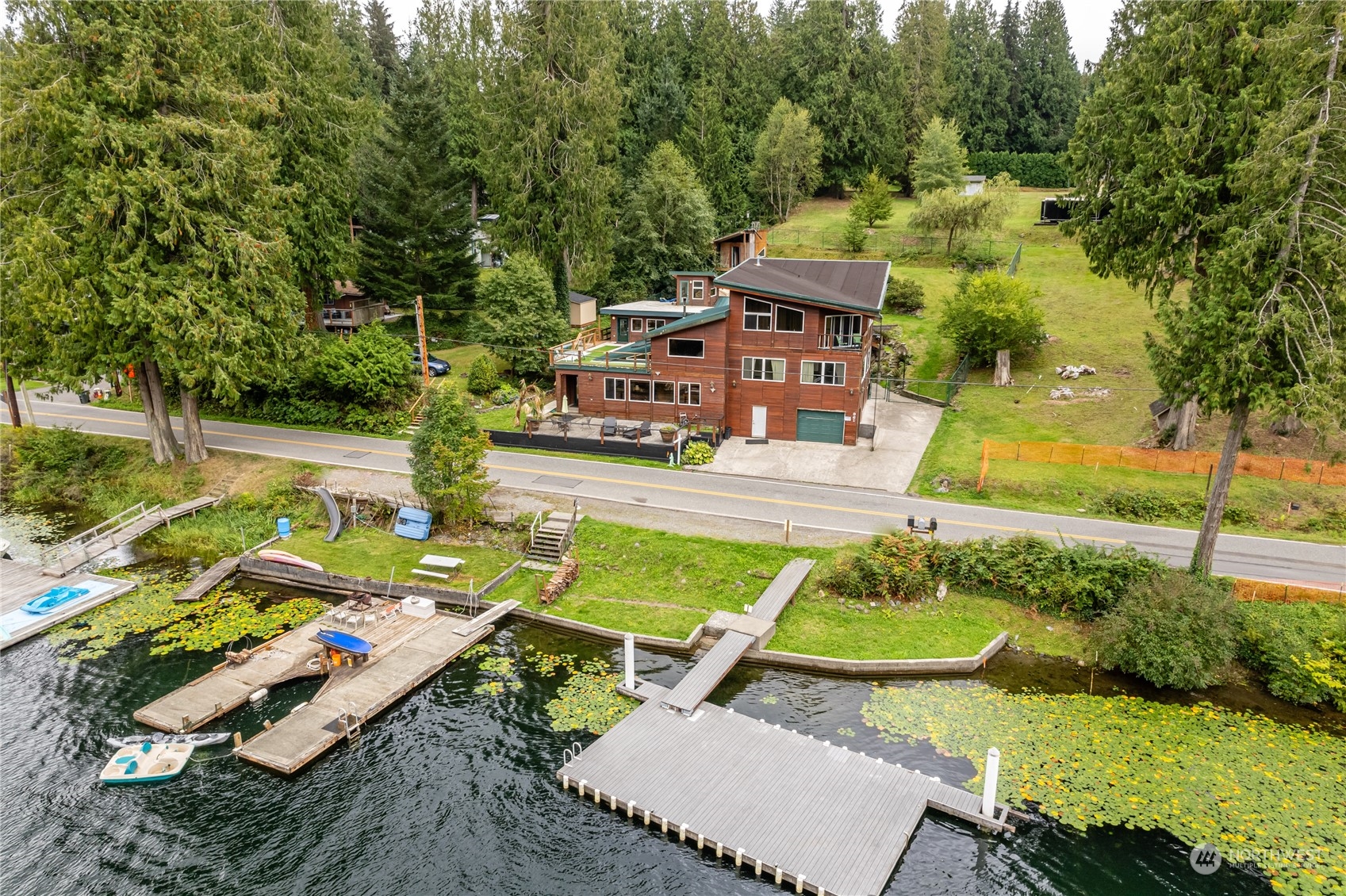 an aerial view of a house with garden space and street view