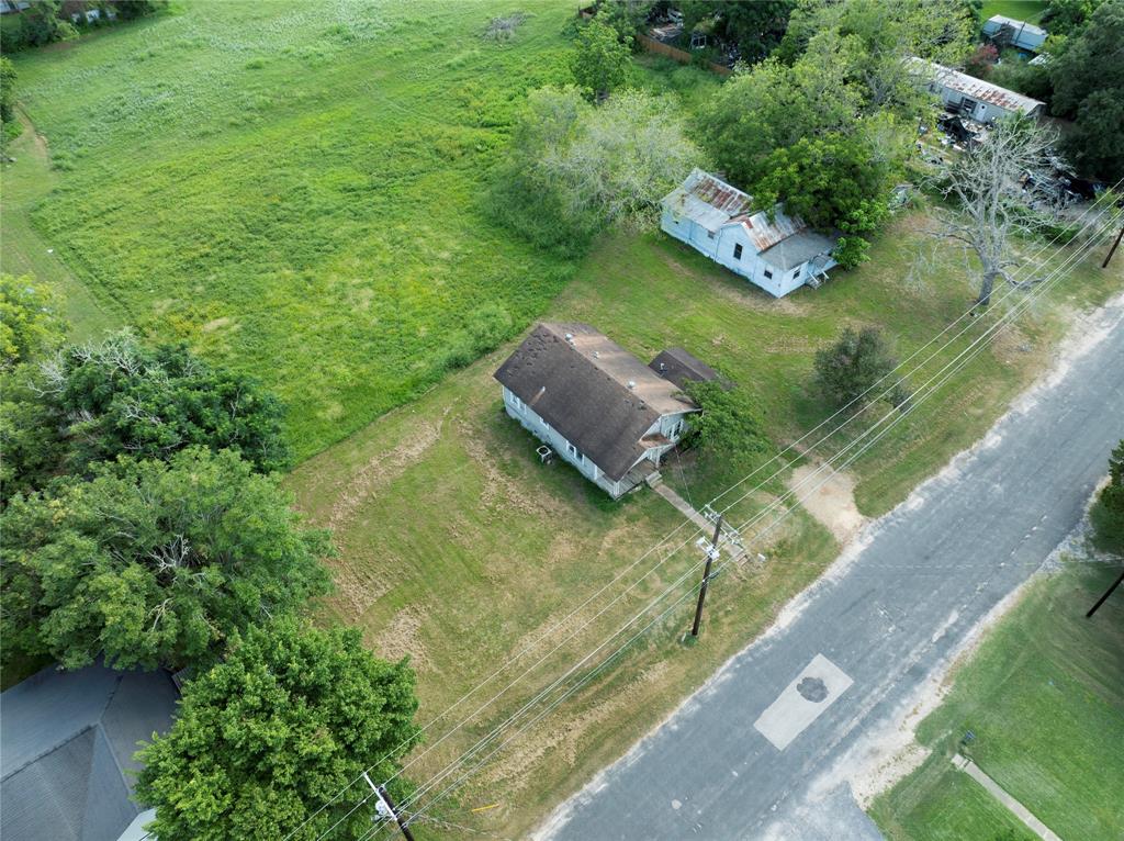 an aerial view of a house with a yard basket ball court and outdoor seating