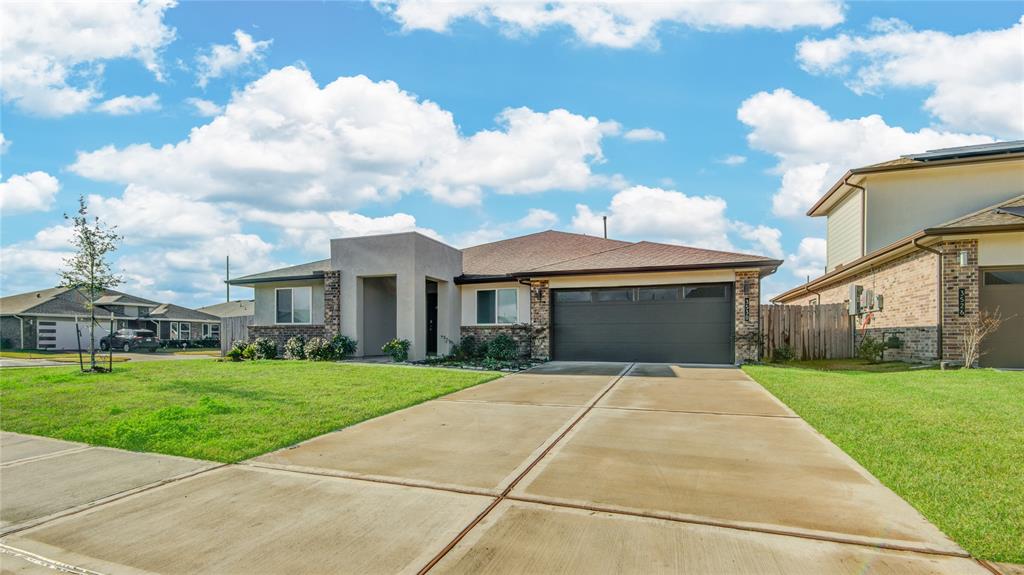 a front view of house with yard and green space