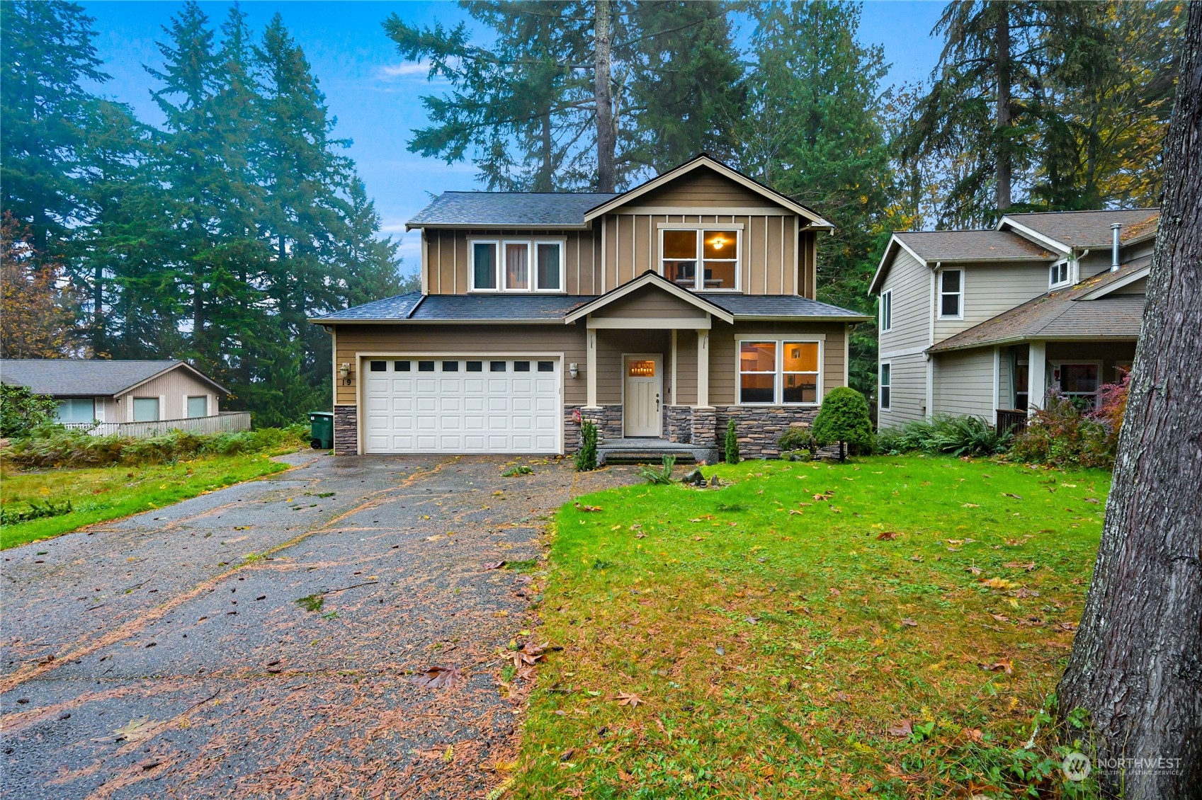 a front view of a house with a yard and garage