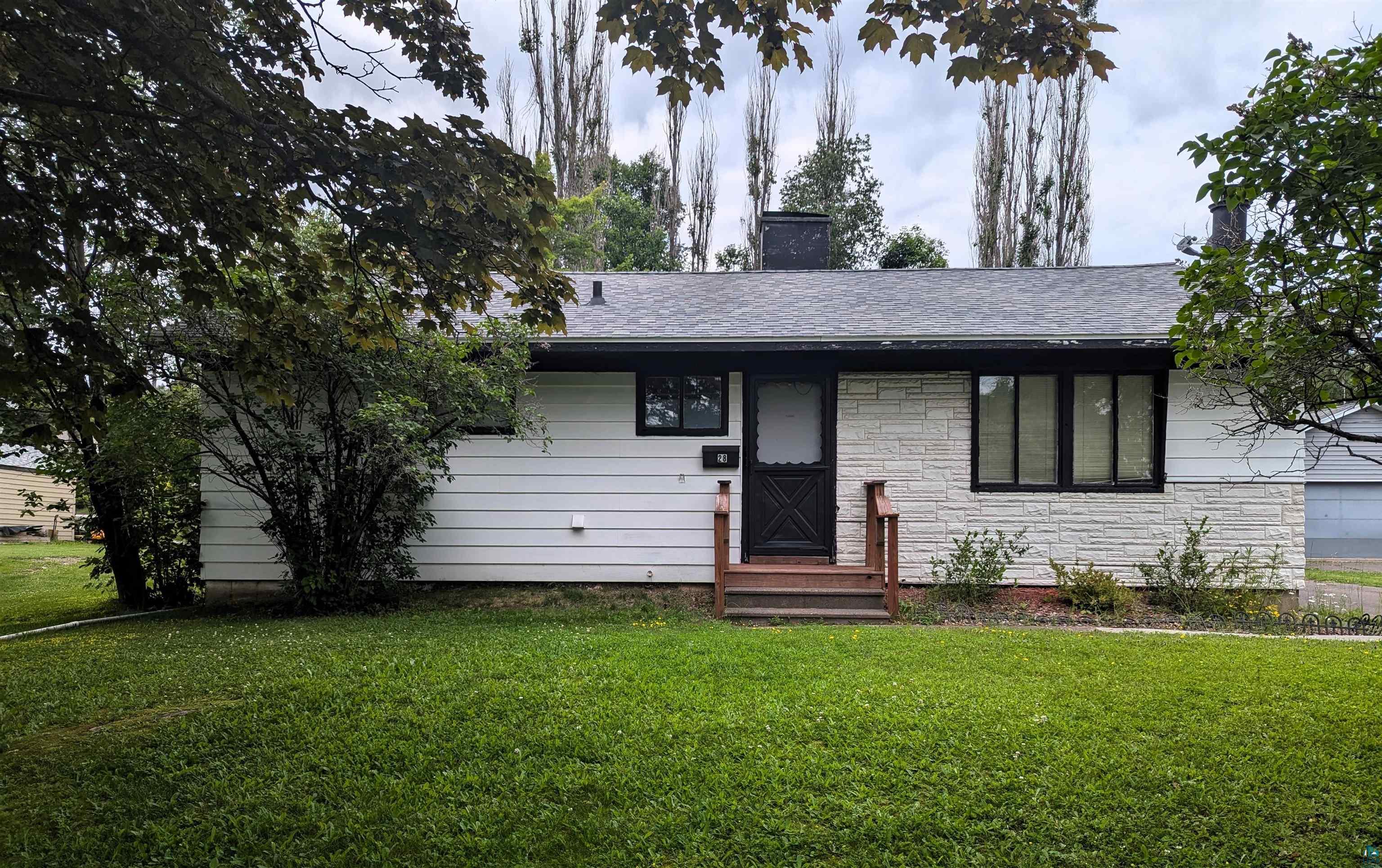 Ranch-style home with a front yard