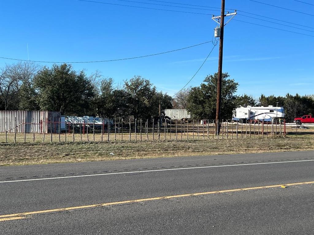 a view of a yard and tree on the road