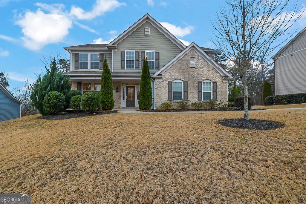 a front view of a house with a yard