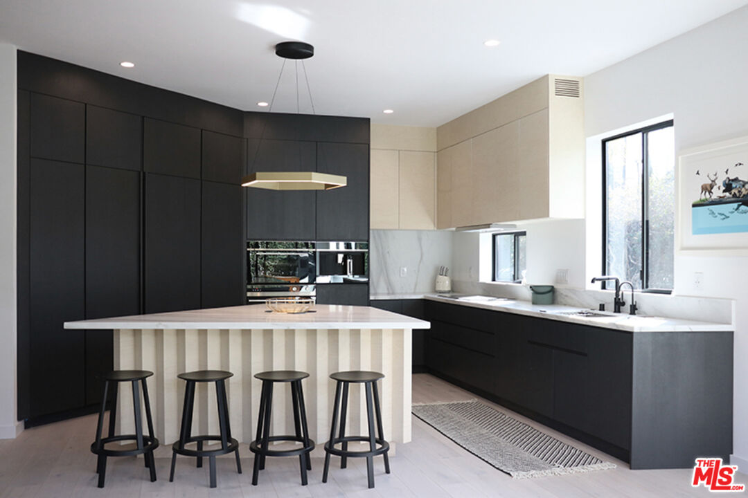 a kitchen with a table and chairs