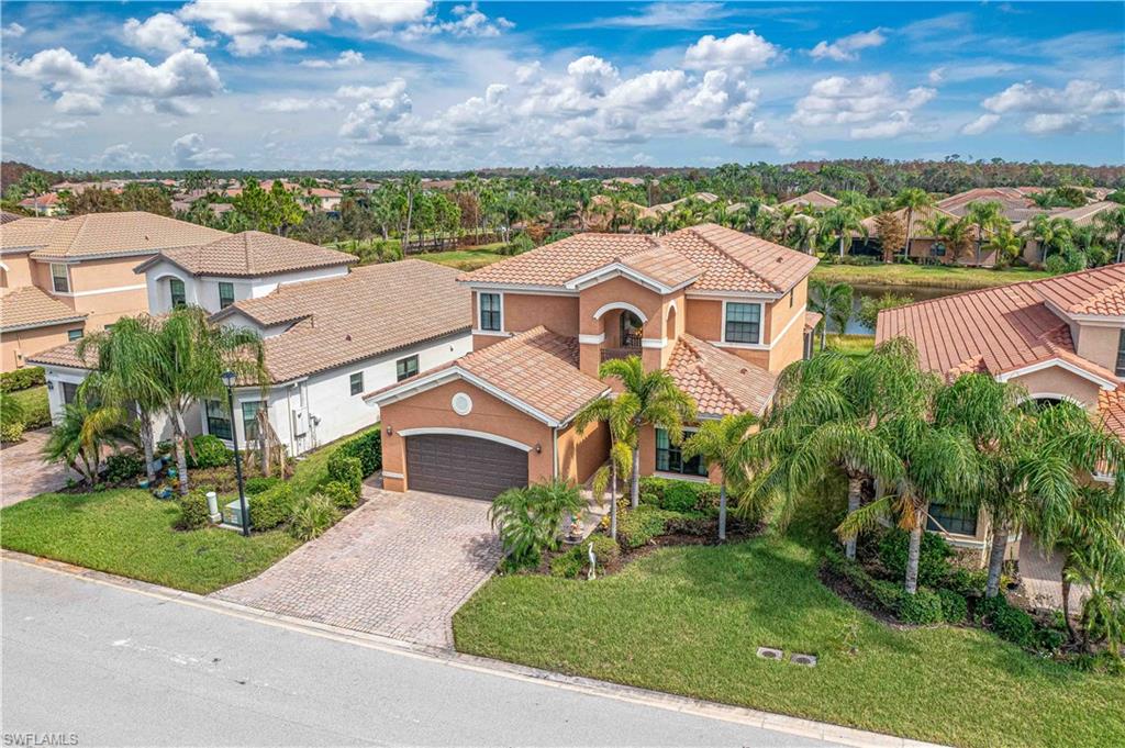 an aerial view of a house with a yard