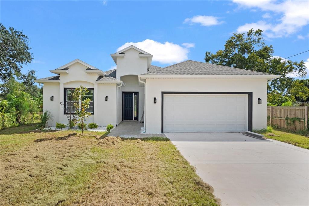 a front view of a house with a yard and garage