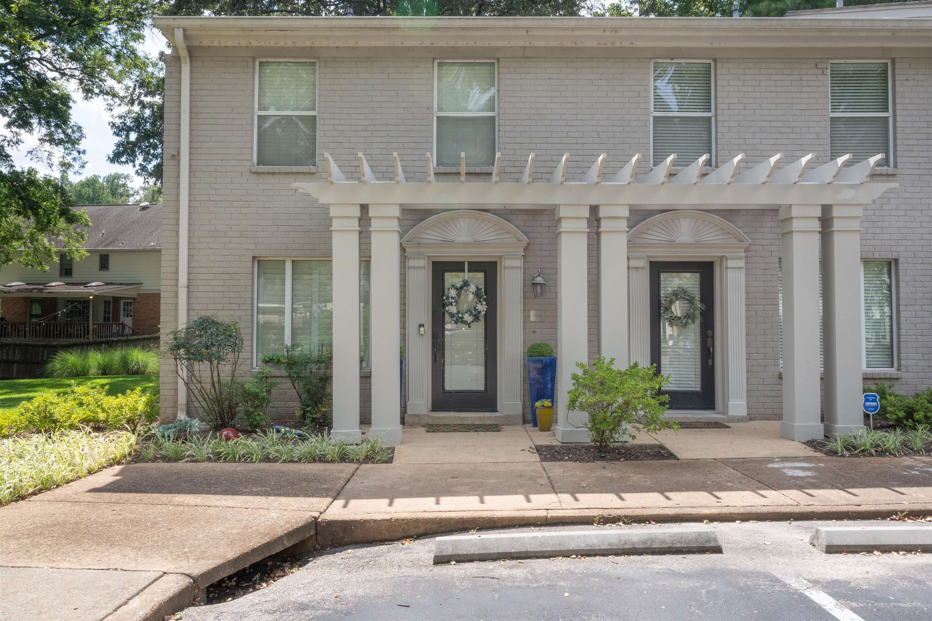 View of front of property with a pergola