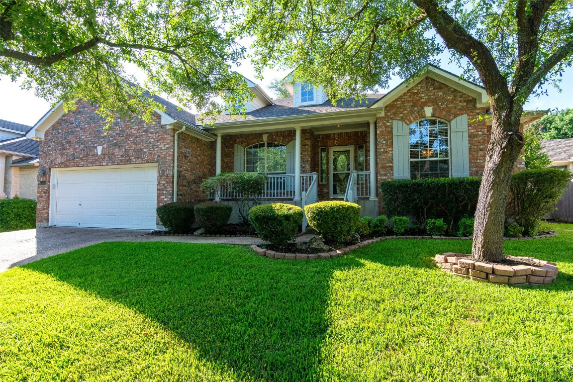 a front view of a house with a yard and porch