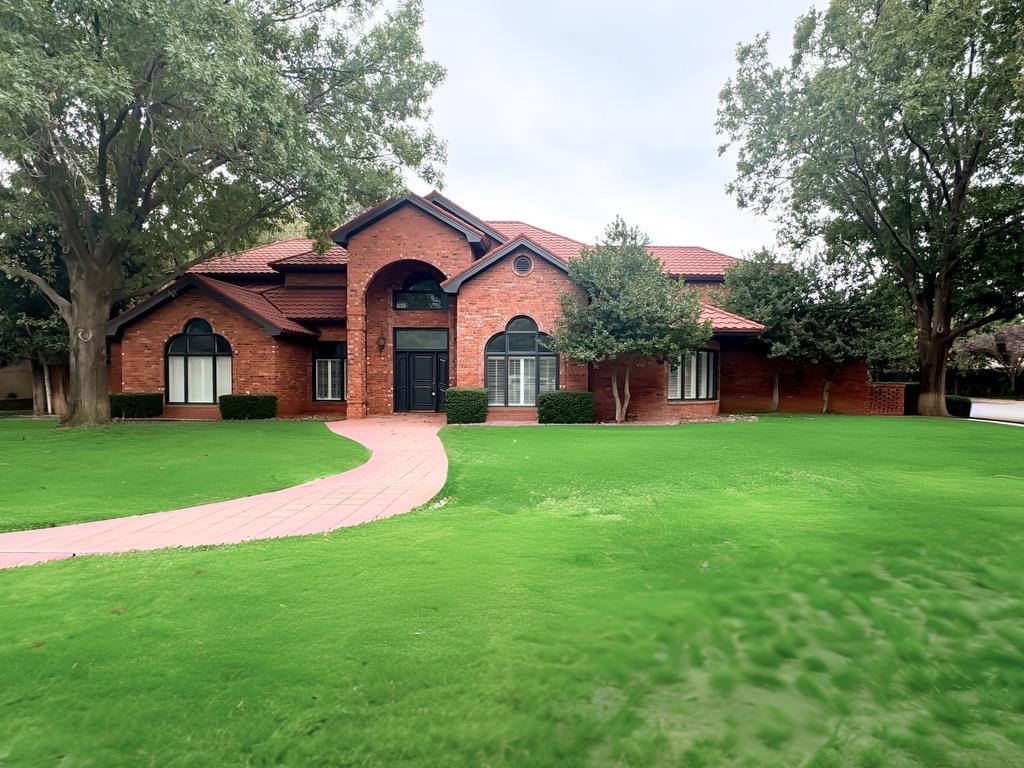 a front view of house with yard and green space