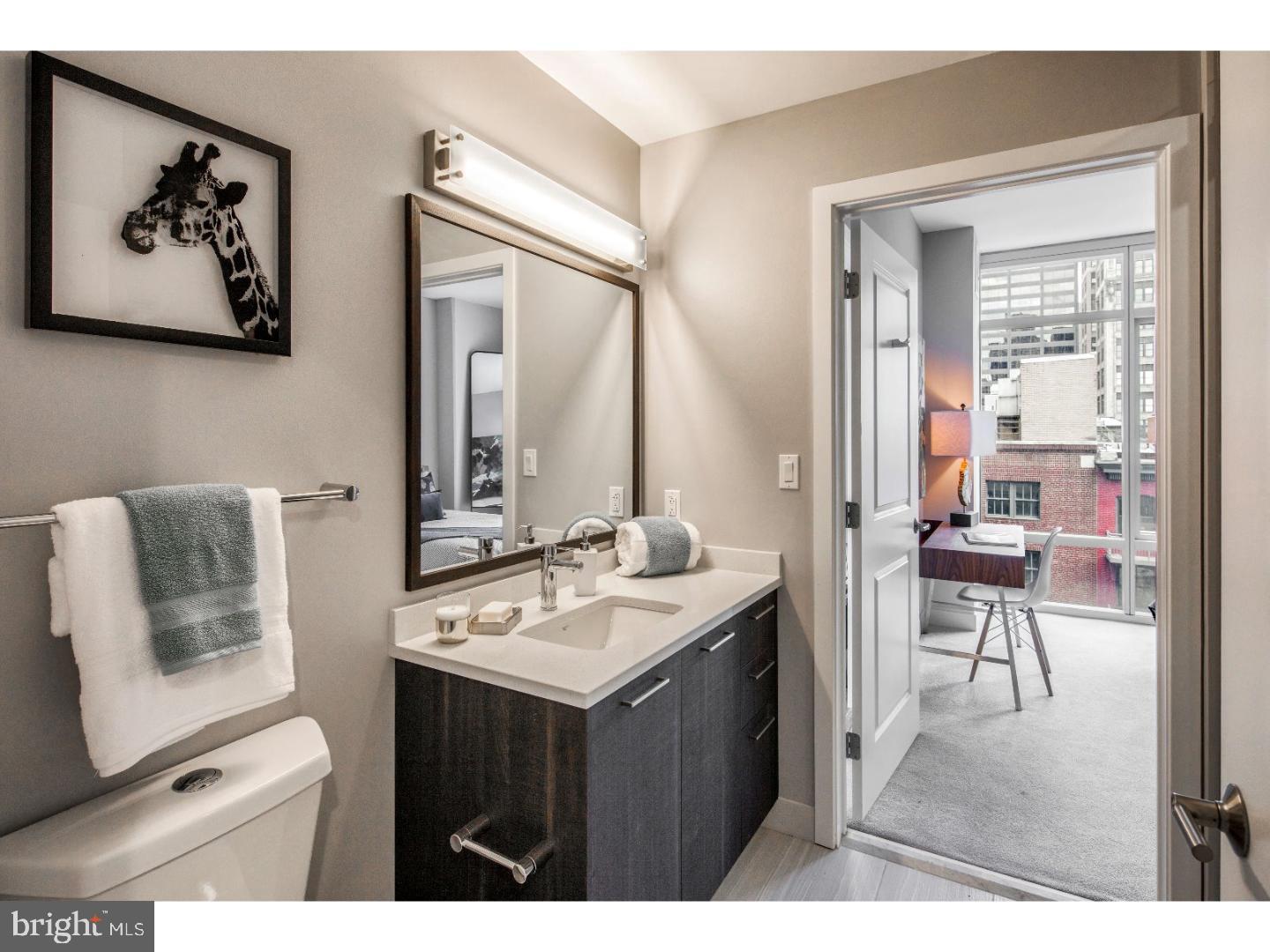 a bathroom with a sink vanity and a mirror