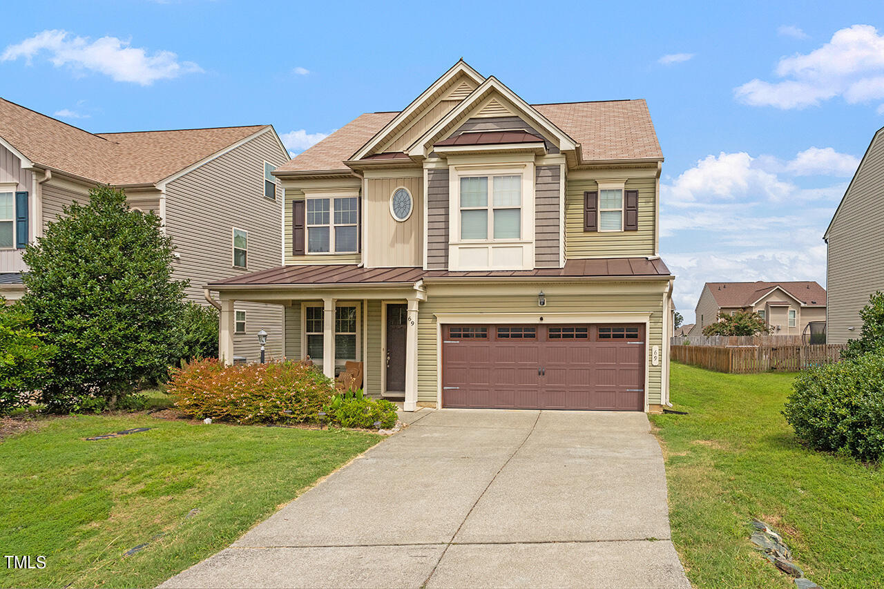 a front view of a house with a yard and garage