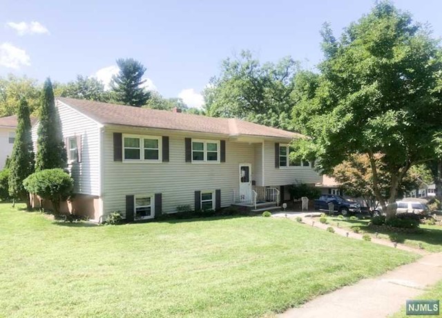 a view of a house with a backyard and sitting area