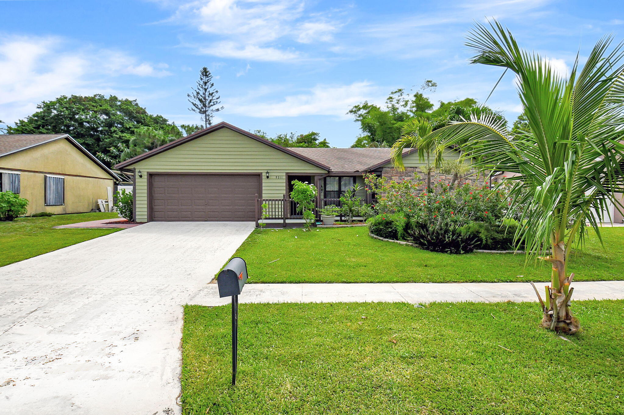 a front view of a house with a garden