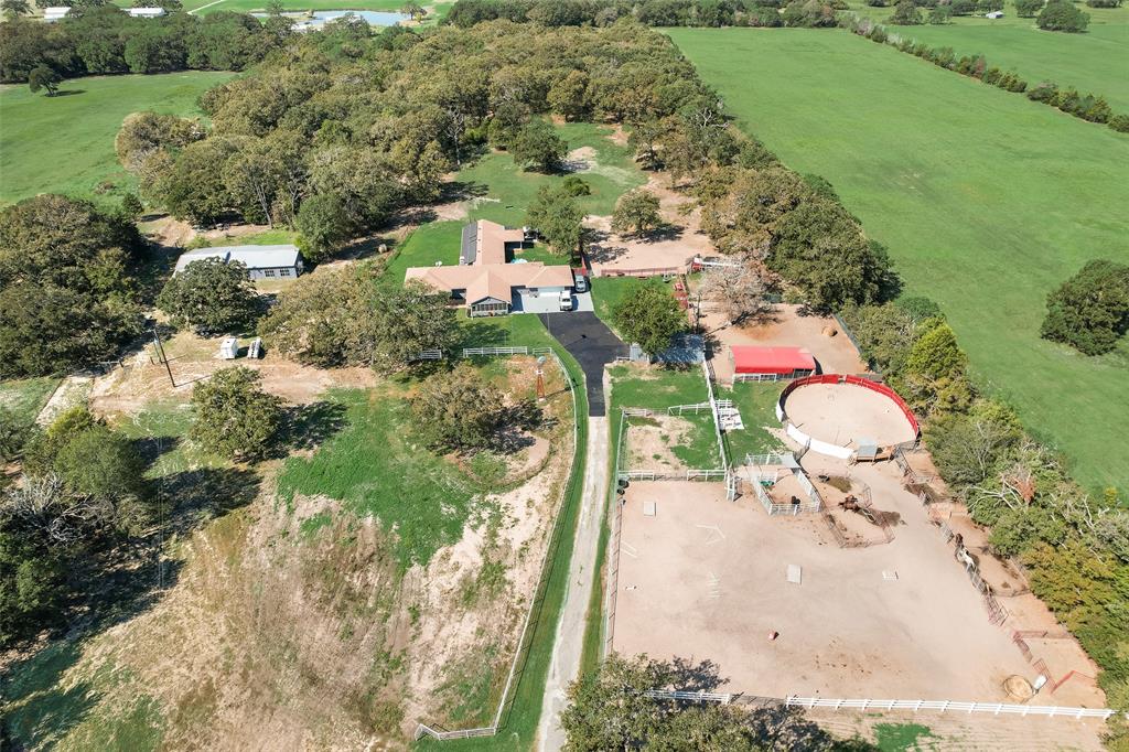 an aerial view of a house with yard swimming pool and outdoor seating