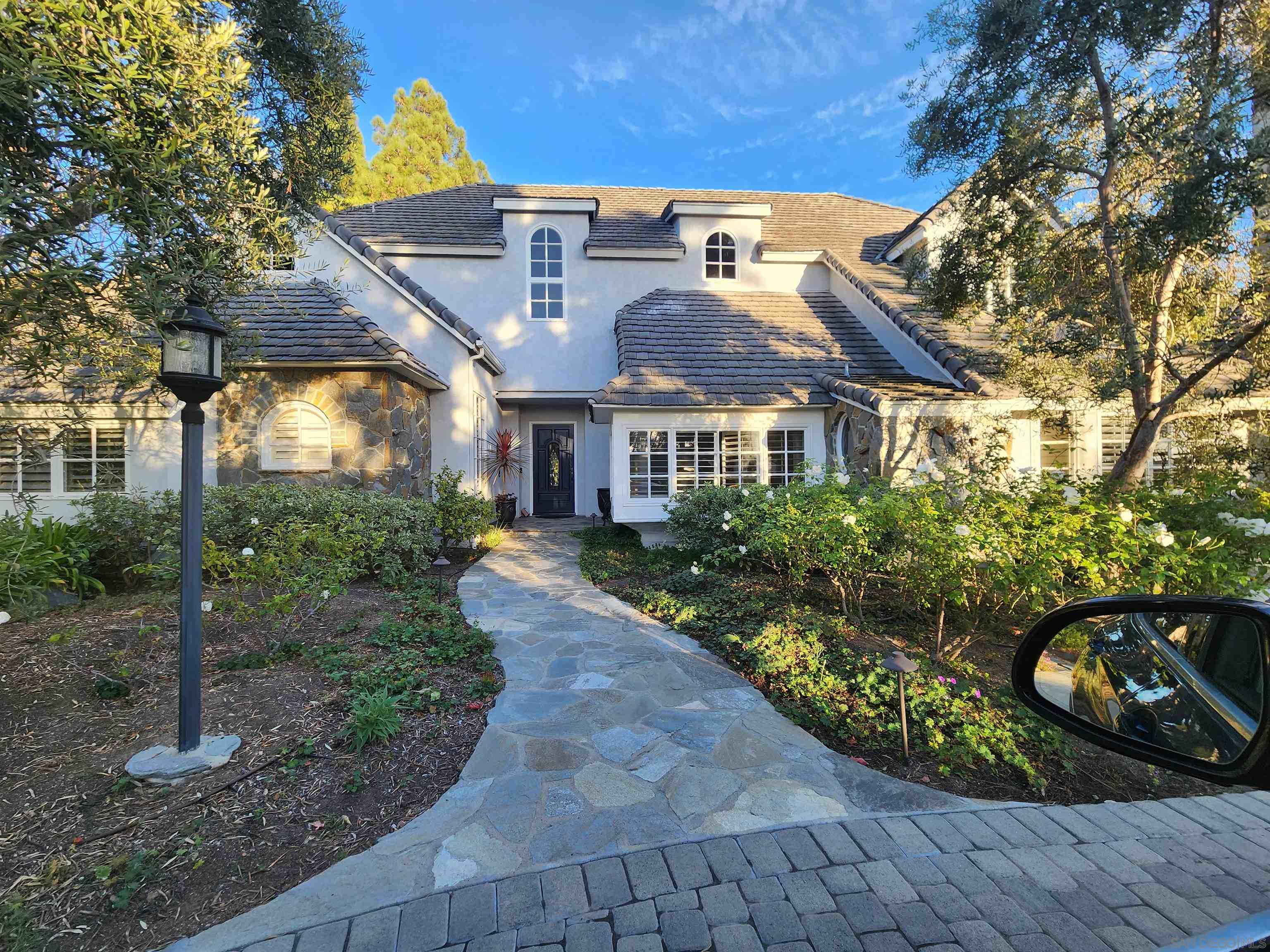 a front view of a house with garden