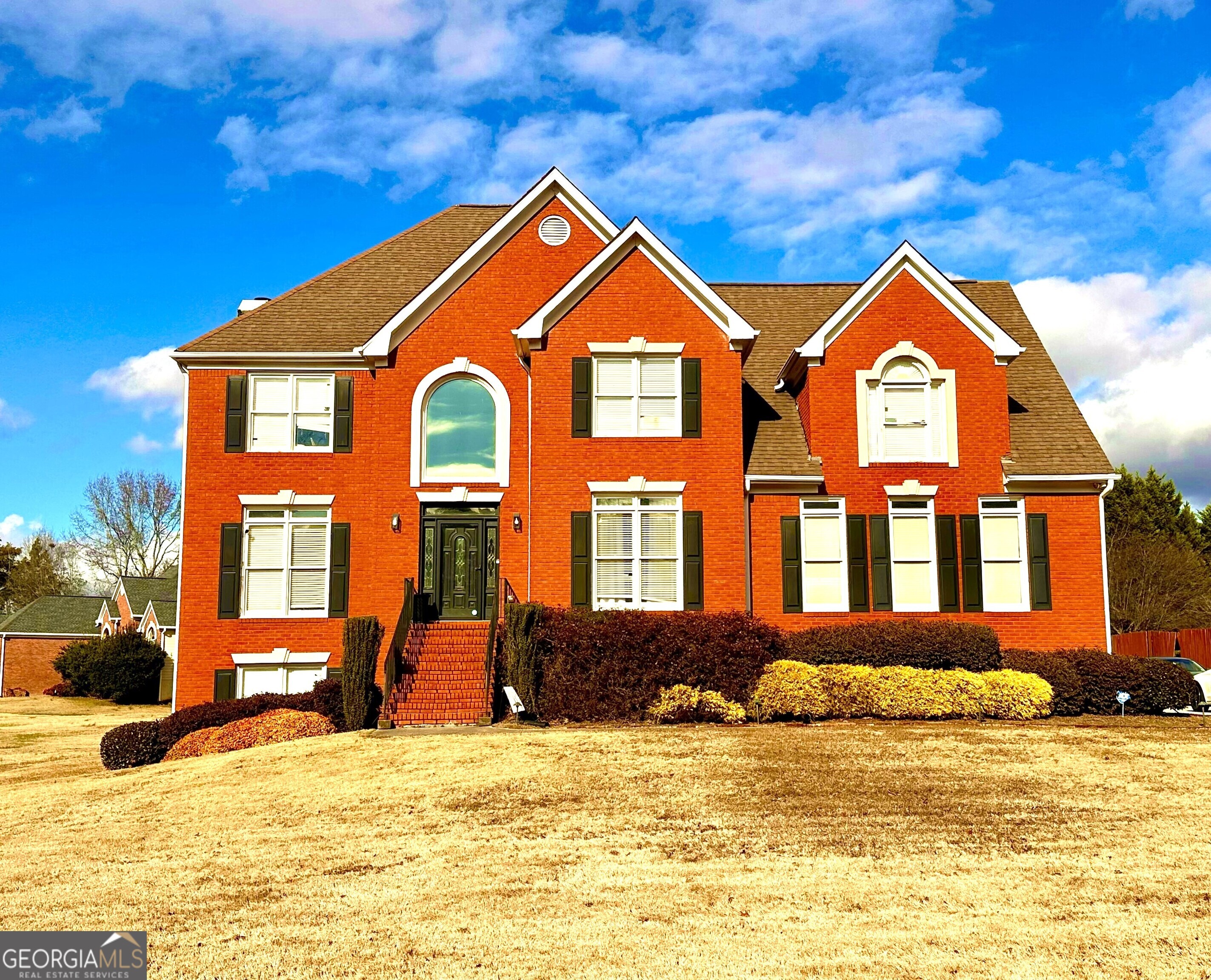 a front view of a house with a yard