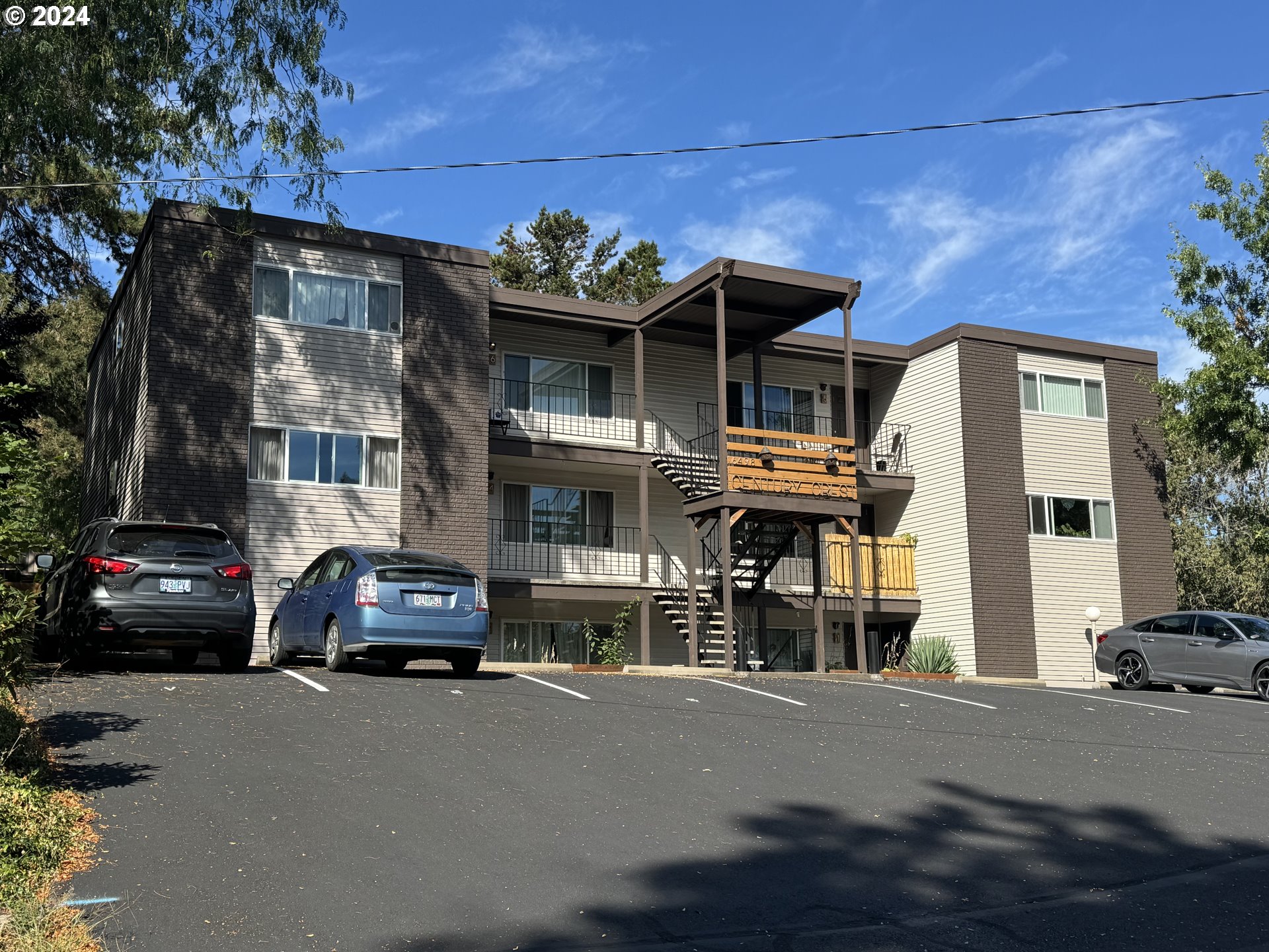 a view of a car park in front of a house