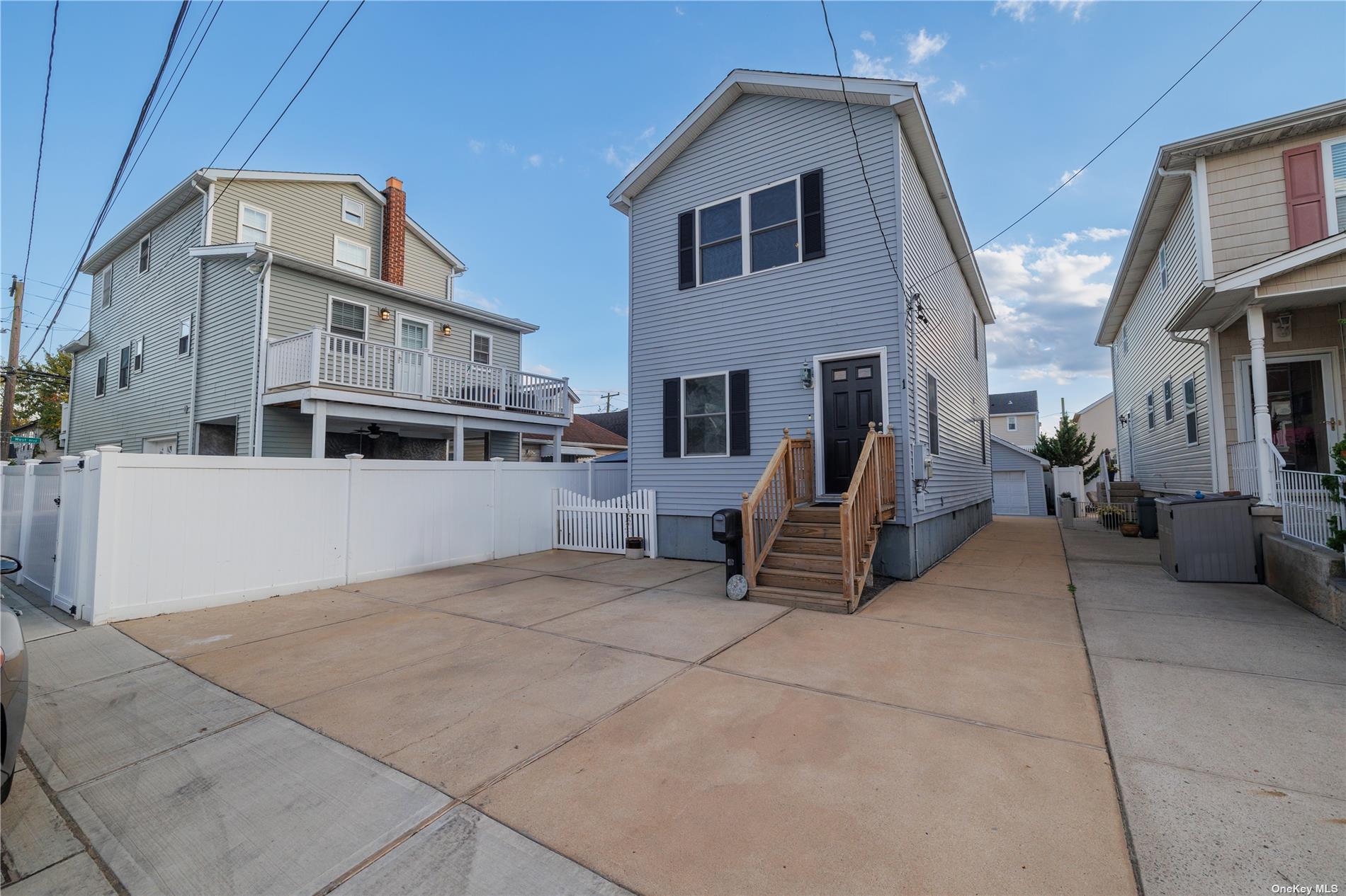 a view of a house with couches next to a yard